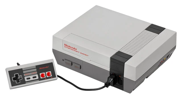 Grey front-loading Nintendo Entertainment System with a rectangular controller attached